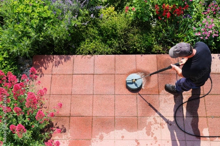 The Exterior Group technicians performing power washing, window cleaning, and gutter cleaning services.