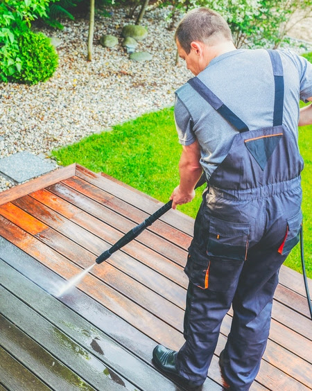 Two The Exterior Group technicians using different top-of-the-line tools to clean residential gutters.