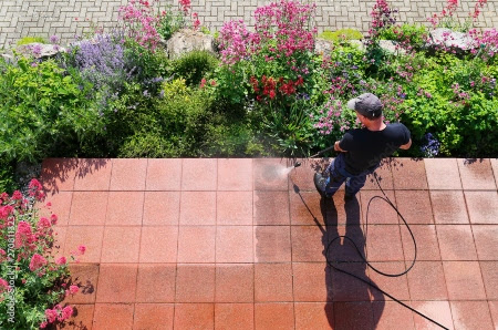 The Exterior Group technicians cleaning gutters using high-end tools.